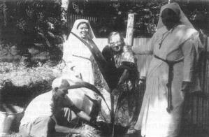 Elizabeth planting a coconut tree at Jobarpar in 1989